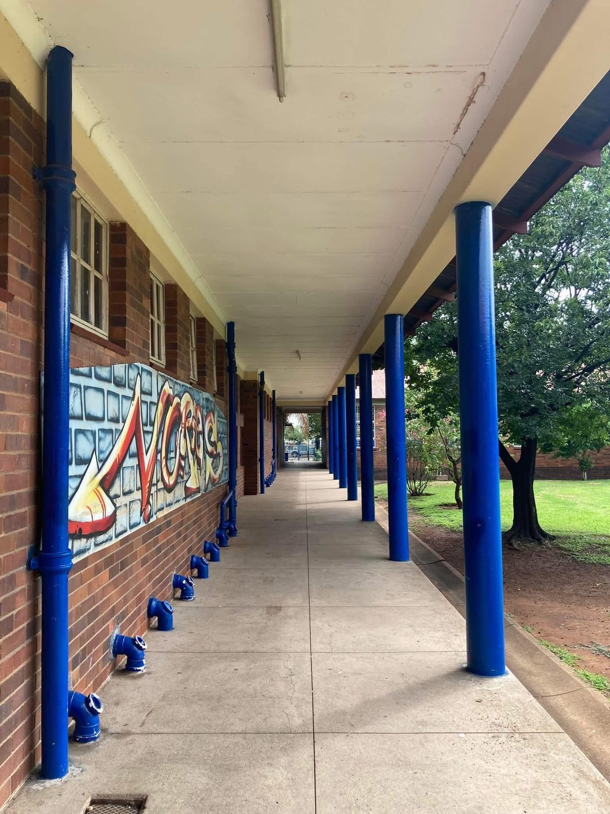 The welcoming corridors of our Johnson Street campus, with the Nories mural painted along the wall