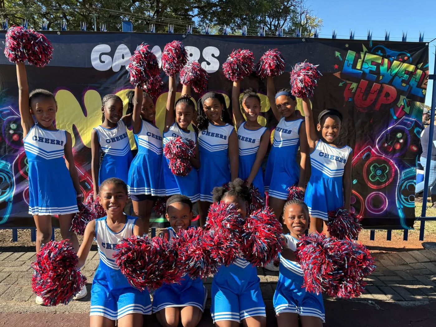 The Nory cheerleading squad posing with red and blue pom-poms
